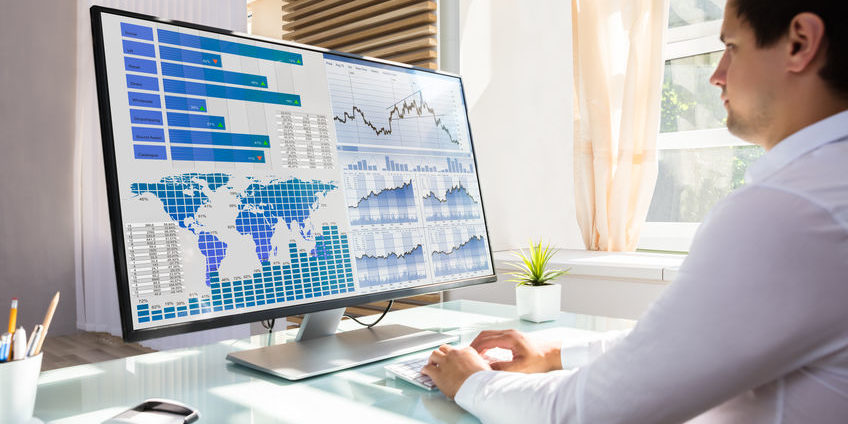 Stock market broker analyzing graph on computer analyzing charts | current market behavior