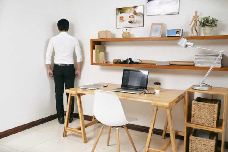take a break from trading | man standing in corner near desk