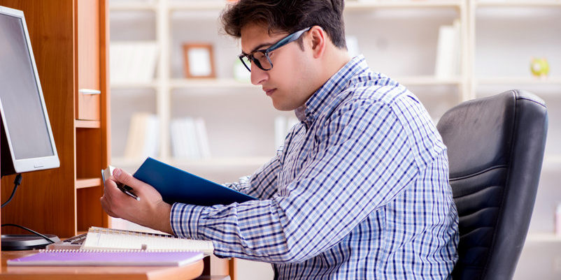 young man reading | options trading best practices