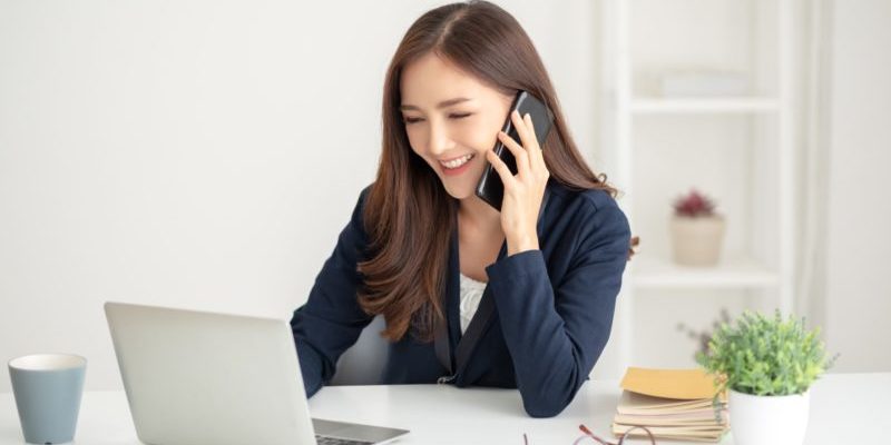 Happy young woman working | bullish sentiment