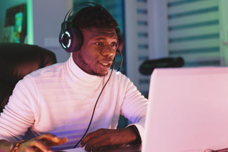 manage low volatility | young man trading at pink computer