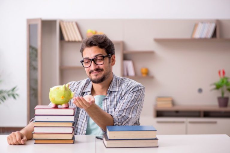 young man with books and a piggy bank | improve your options trading skills