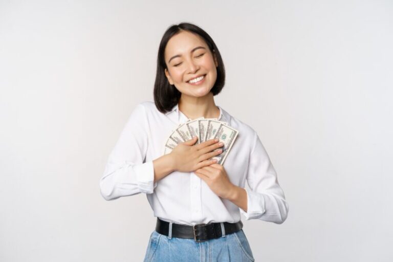 woman hugging money | trading fear and greed