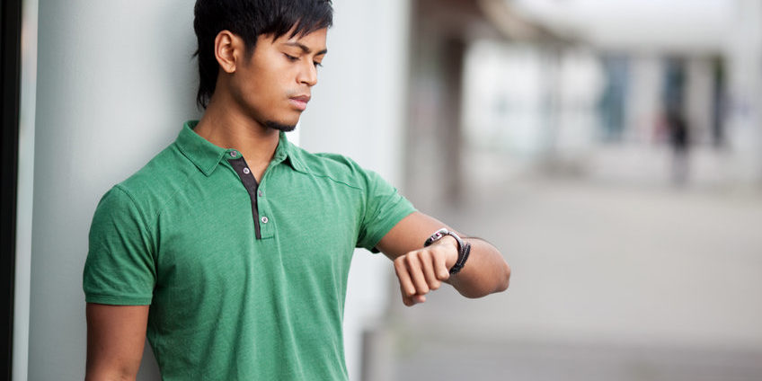 Young man is looking at his watch checking the time young man checking his watch |secret to trading success