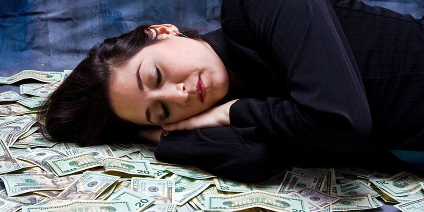 3292092_s sleeping on a pile of money | protect your market gains
