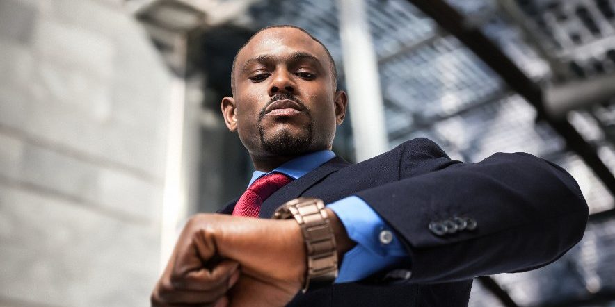 businessman looking at his watch | patience in options trading