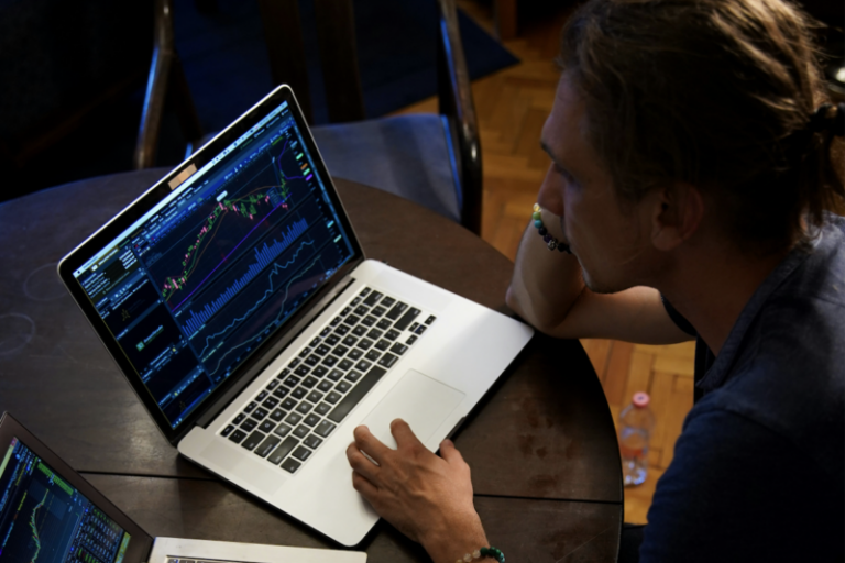 Man staring at chart on laptop | markets stuck in chopfest