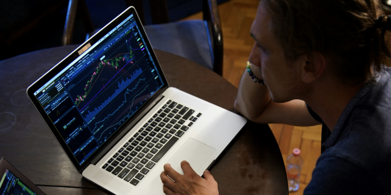 Screenshot 2026-03-23 at 10.16.37 AM Man staring at chart on laptop | markets stuck in chopfest