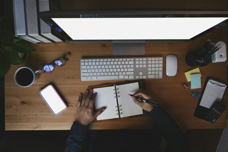 trader sitting at desk and writing in journal | reflect on options trading success