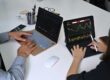 two people trading on their laptops | year end trading strategies
