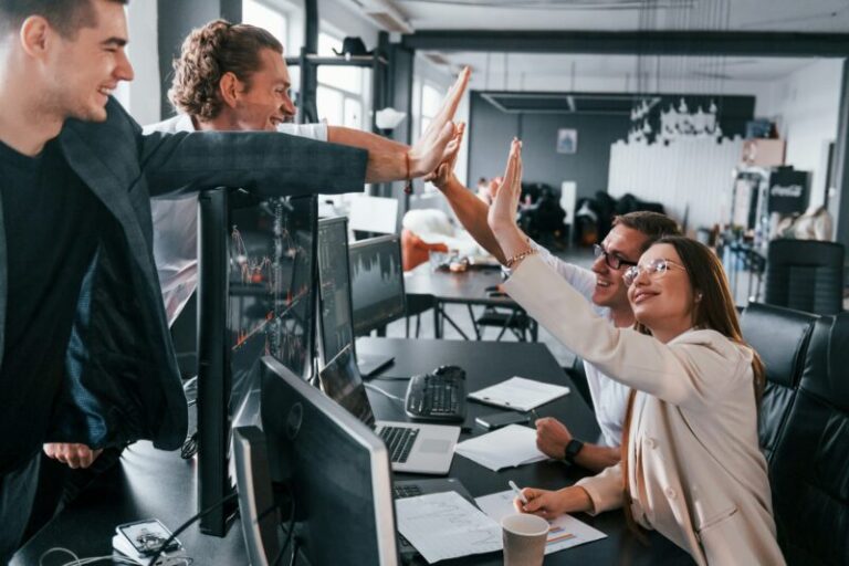 traders celebrating winning trade | options Greek vega