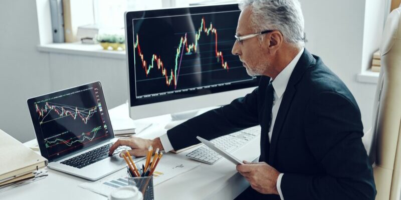 trader looking at bearish chart | buying the dip right now