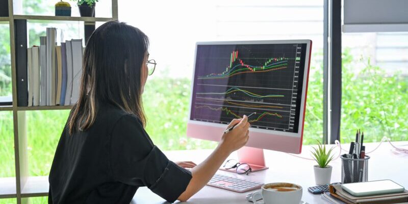 woman analyzing stock chart on monitor | stock market indicator