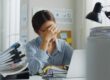 nervous woman holding her head in front of a computer | MOVE index