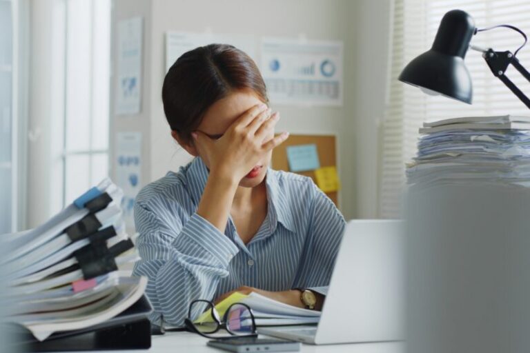 nervous woman holding her head in front of a computer | MOVE index