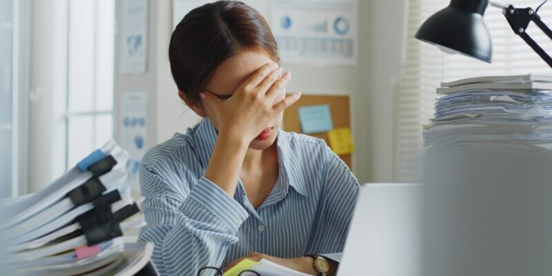 nervous woman holding her head in front of a computer | MOVE index