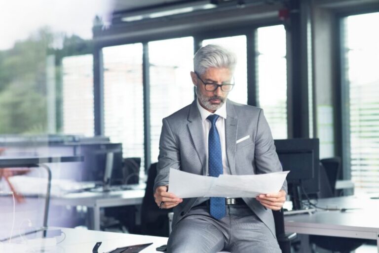 Trader reading printed reports | Federal Reserve reports