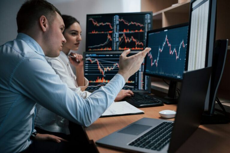 traders analyzing charts on computer monitors | obscure technical indicators