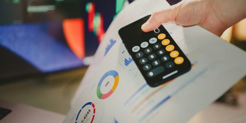 calculator, price charts, and stock charts on monitor | how to use earnings estimates