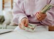 female trader counting money | put selling strategy