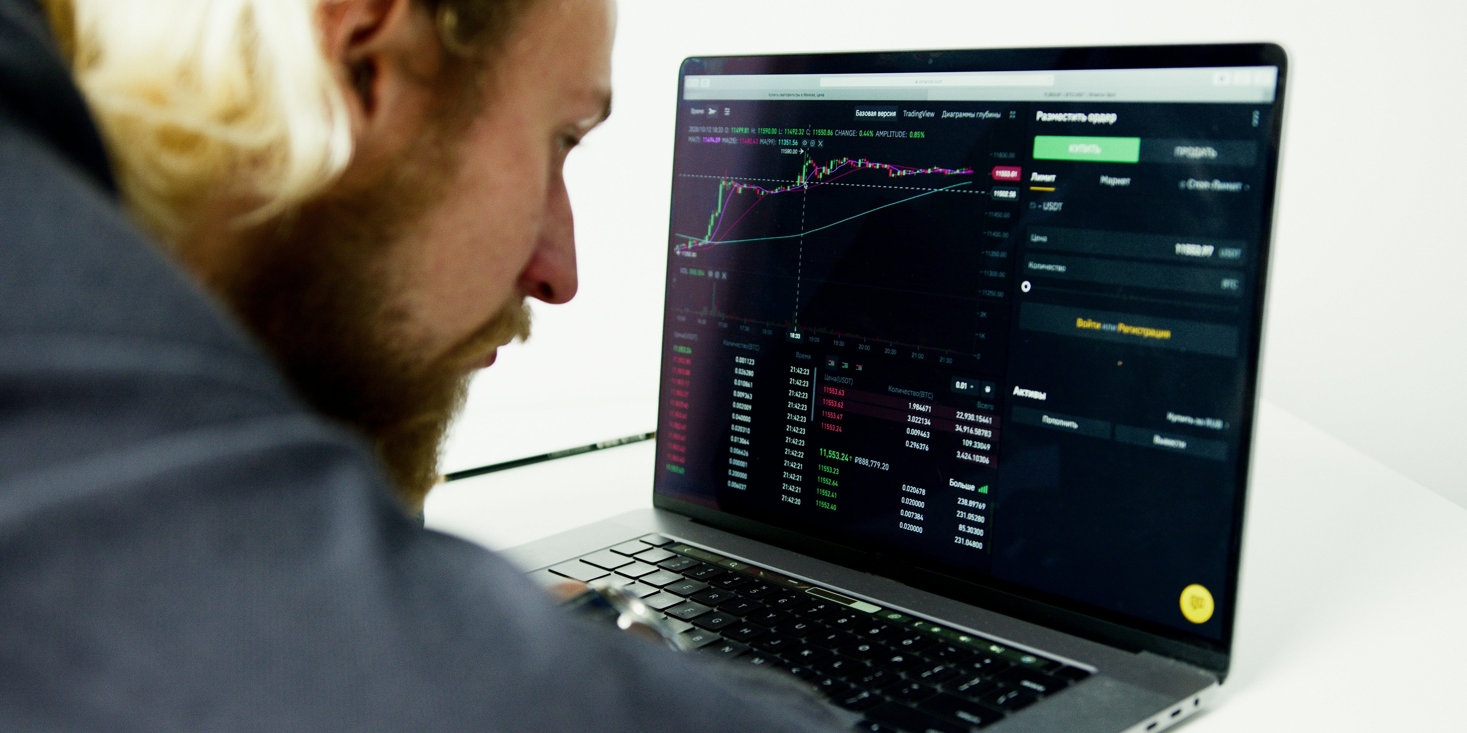 man closely watching stock chart | overbought stocks