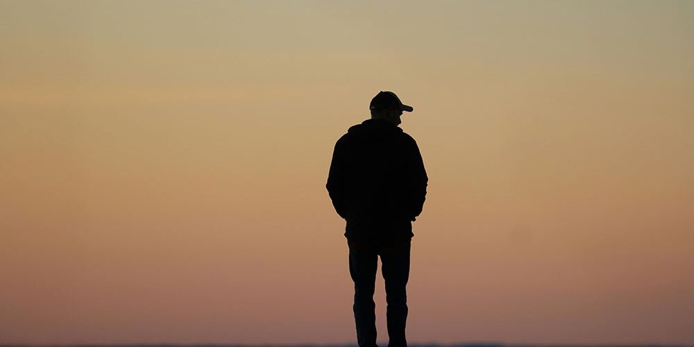 man staring out at the ocean | current market volatility