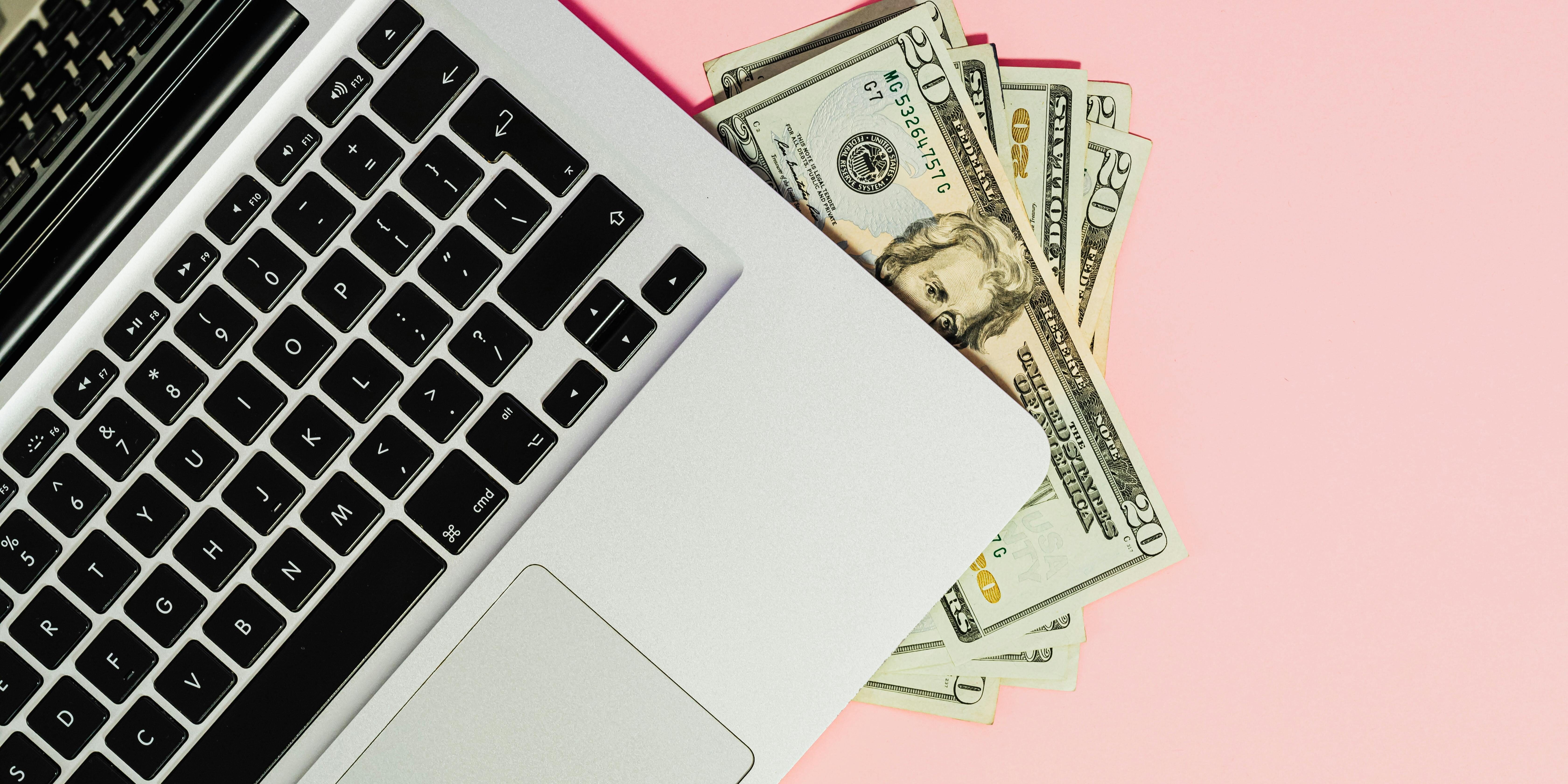money tucked under laptop | cash and risk management