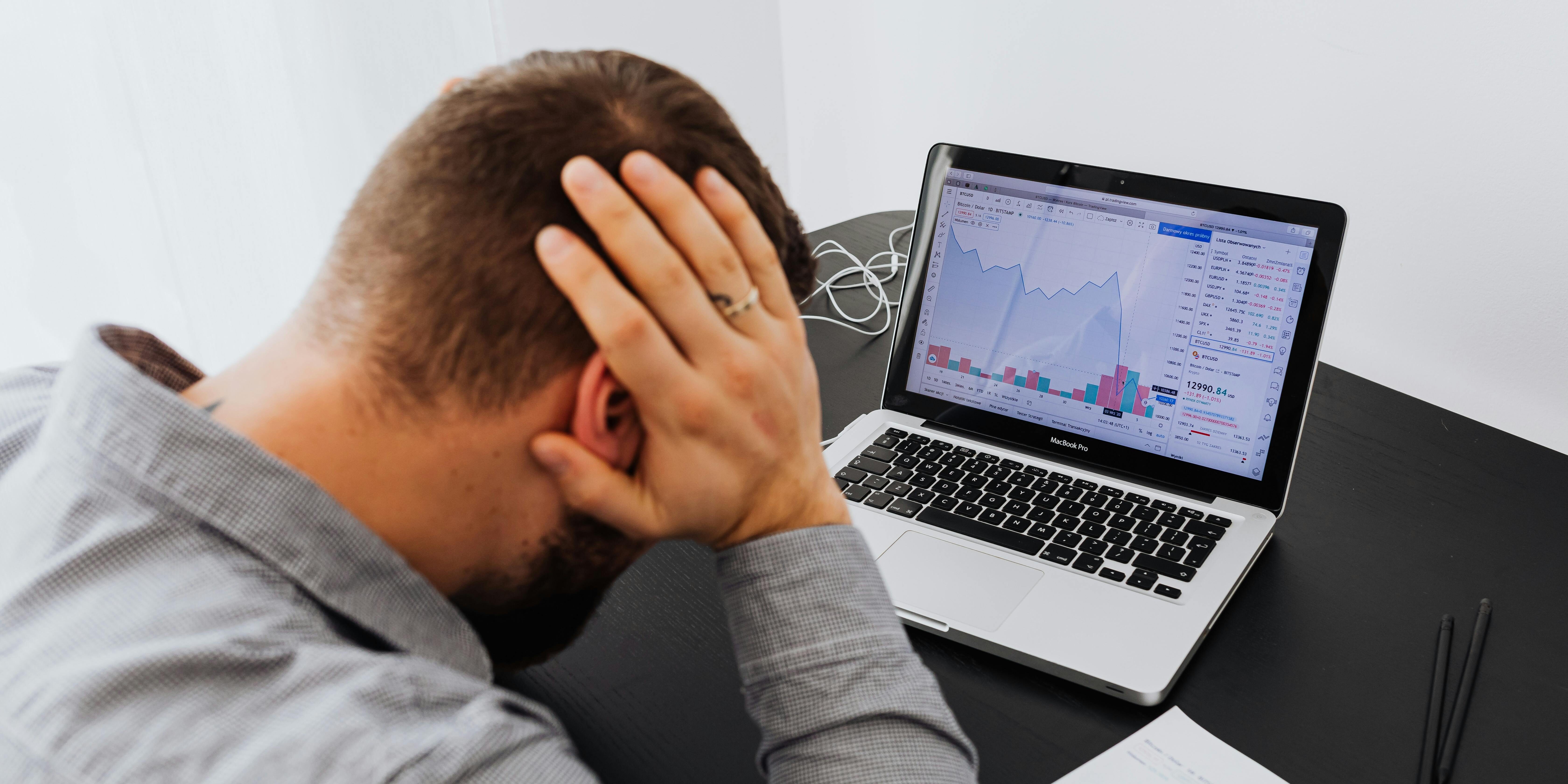 upset trader in front of his computer | recession