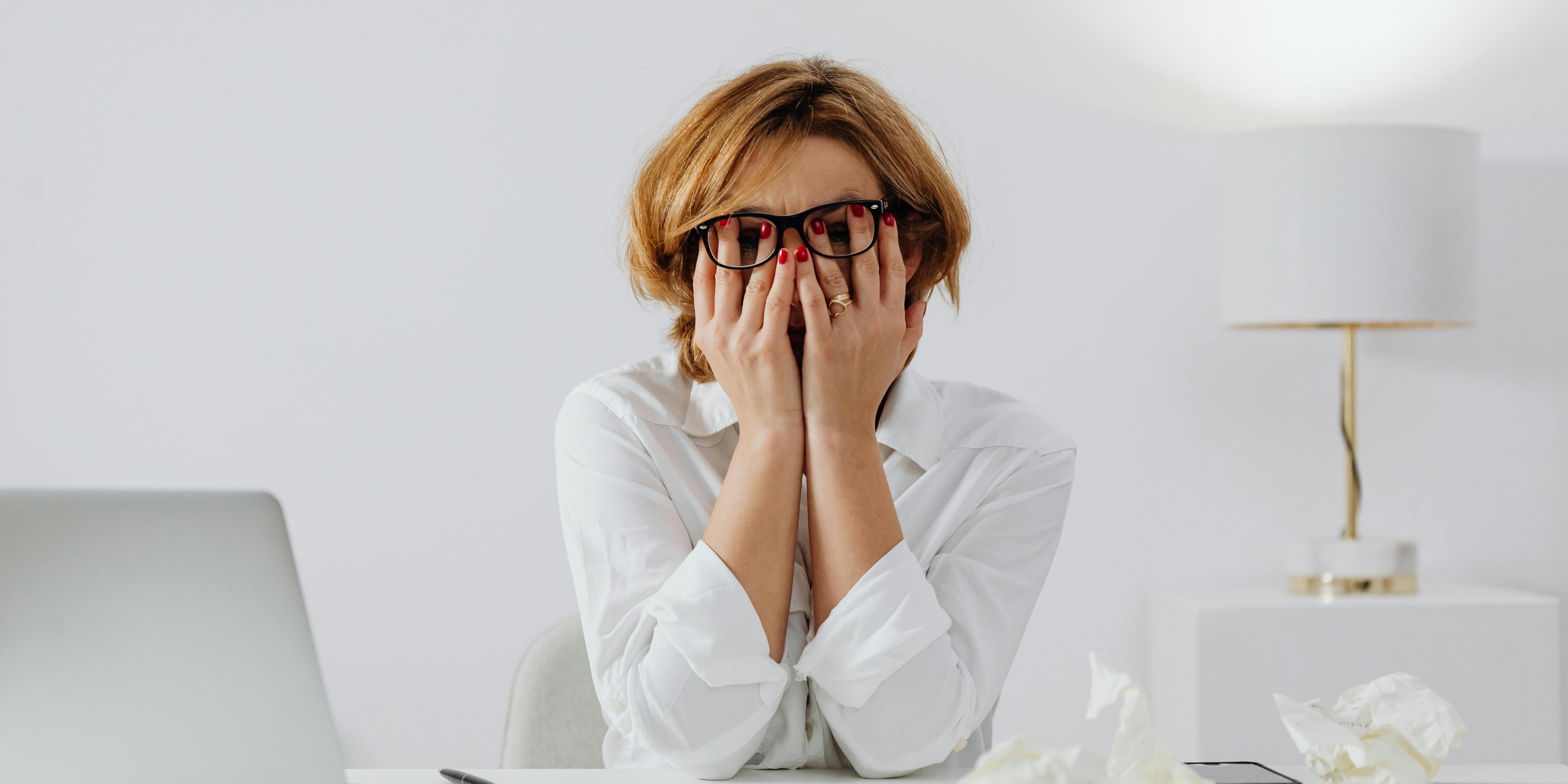 frustrated woman covering face with hands | market psychology