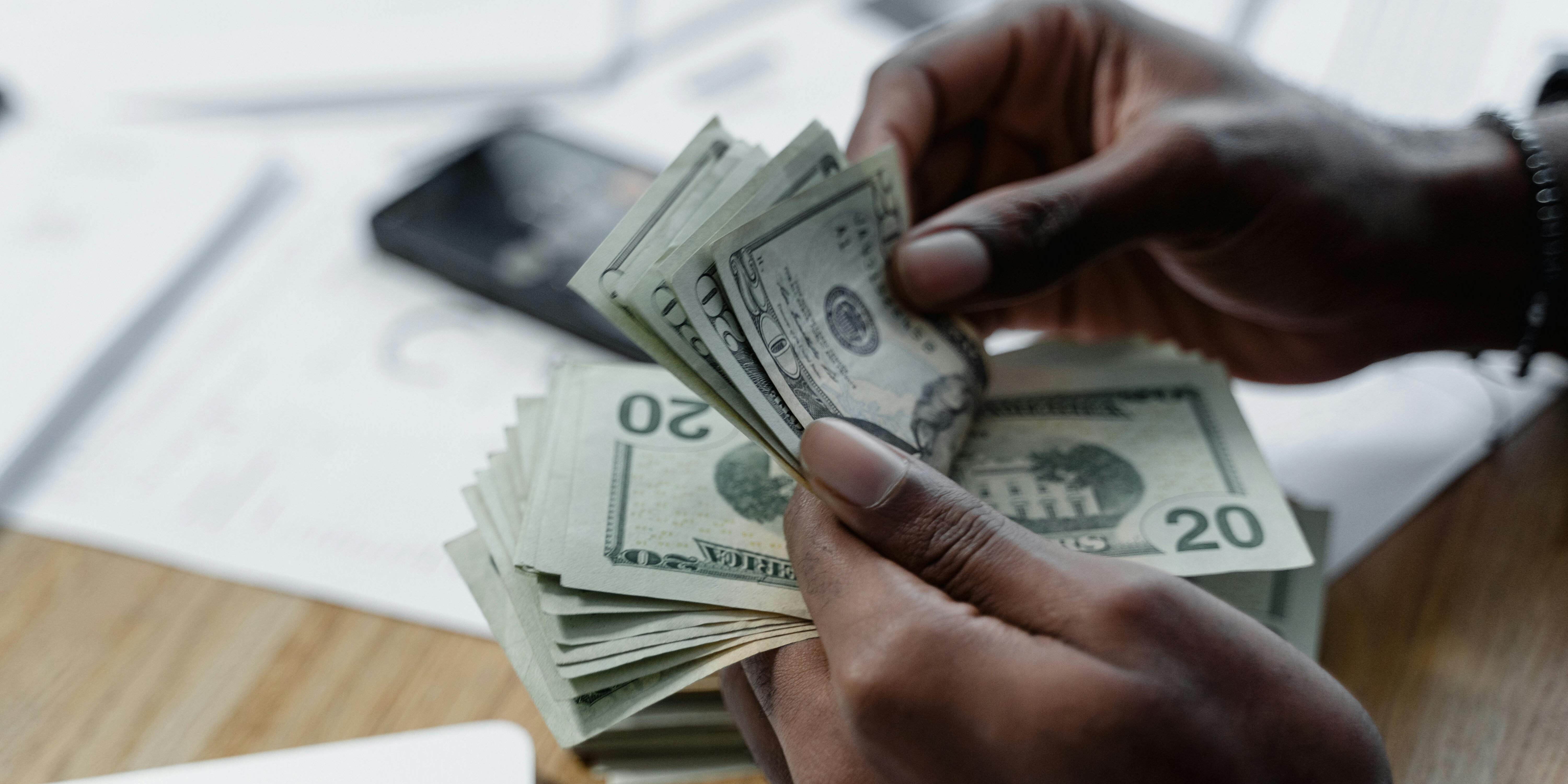 pexels-tima-miroshnichenko-6693632 person counting money | buy and sell option puts