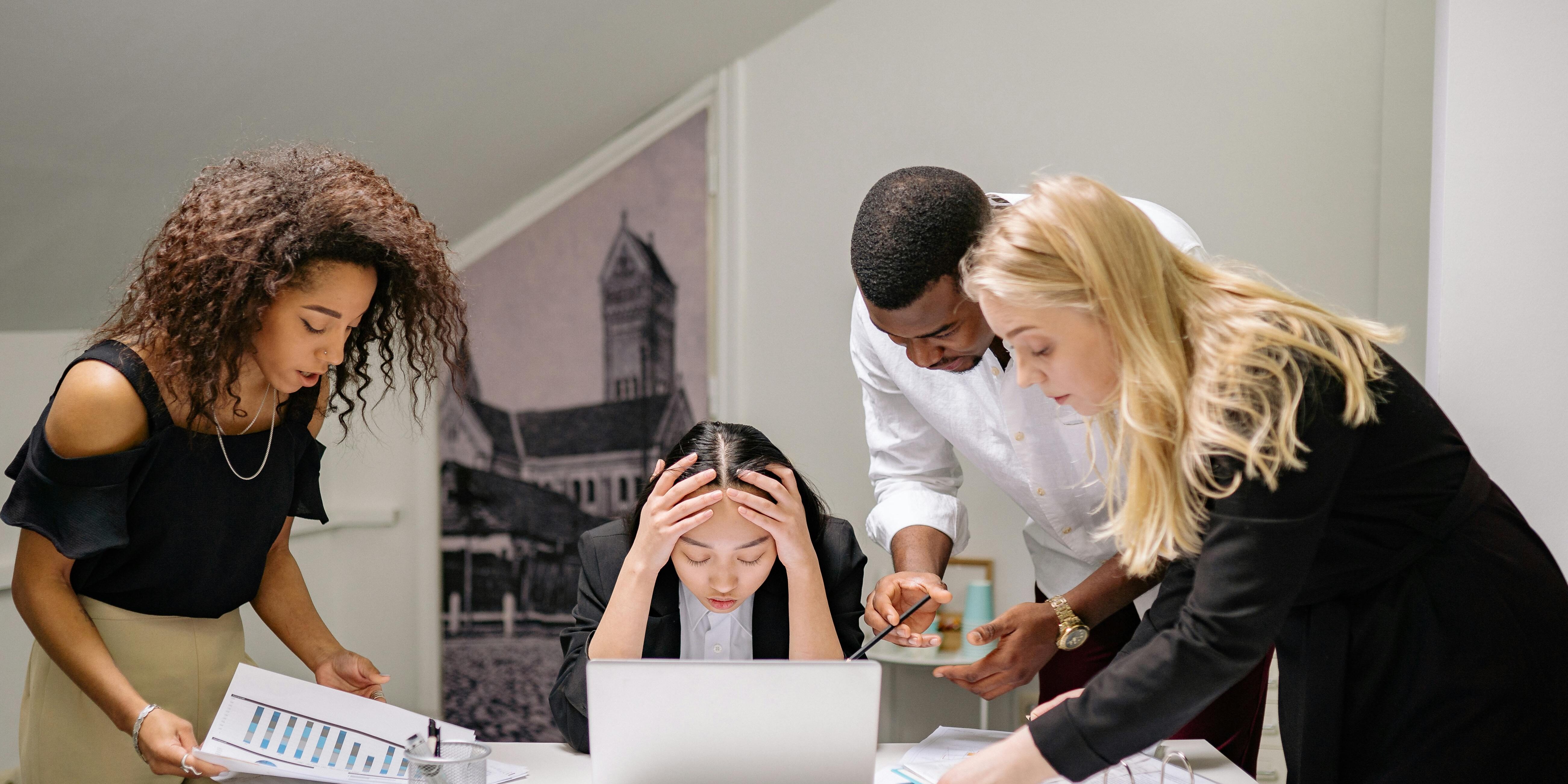 pexels-yankrukov-7640766 people huddled around a scared colleague at work | how to master trading psychology