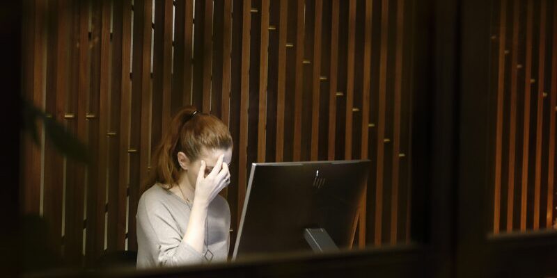 vasilis-caravitis-WGOpvIKwq3Y-unsplash anxious woman sitting in front of computer | bull market anxiety
