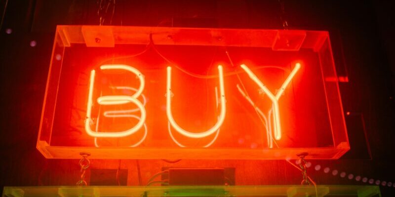 wesley-tingey-lH7y_R-xQhw-unsplash neon "buy" sign | buying the dip
